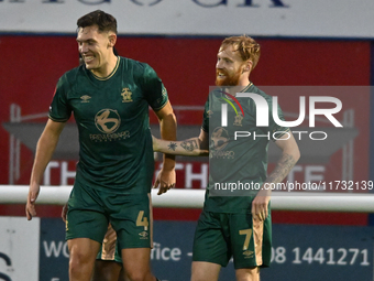 James Brophy (7, Cambridge United) celebrates after scoring the team's first goal during the FA Cup First Round match between Woking and Cam...