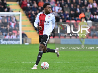 Timi Odusina (5 Woking) controls the ball during the FA Cup First Round match between Woking and Cambridge United at the Kingfield Stadium i...