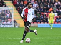 Timi Odusina (5 Woking) controls the ball during the FA Cup First Round match between Woking and Cambridge United at the Kingfield Stadium i...