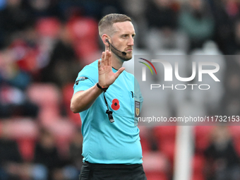 Referee Jamie O'Connor gestures during the FA Cup First Round match between Woking and Cambridge United at the Kingfield Stadium in Woking,...