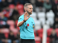 Referee Jamie O'Connor gestures during the FA Cup First Round match between Woking and Cambridge United at the Kingfield Stadium in Woking,...