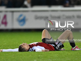 Jamie Andrews (6 Woking) lies on the floor after the final whistle during the FA Cup First Round match between Woking and Cambridge United a...