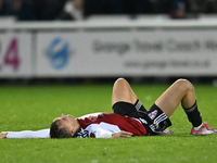 Jamie Andrews (6 Woking) lies on the floor after the final whistle during the FA Cup First Round match between Woking and Cambridge United a...