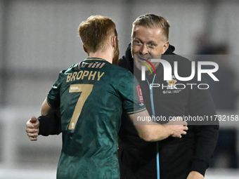 Manager Garry Monk of Cambridge United congratulates James Brophy, number 7 of Cambridge United, after the final whistle during the FA Cup F...