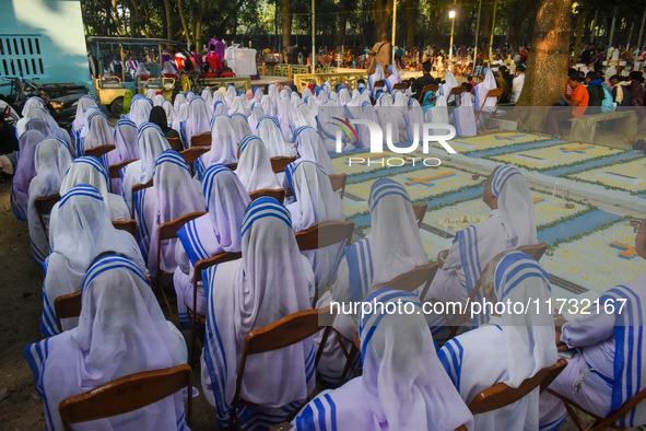 Sisters of Missionaries of Charity pray in front of graves during All Souls' Day observance at a cemetery 80 kilometers outside Kolkata, Ind...