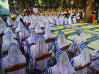 Sisters of Missionaries of Charity pray in front of graves during All Souls' Day observance at a cemetery 80 kilometers outside Kolkata, Ind...