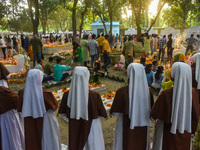 Sisters of Missionaries of Charity pray in front of graves during All Souls' Day observance at a cemetery 80 kilometers outside Kolkata, Ind...