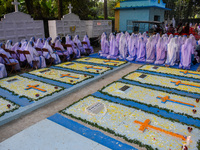 Sisters of Missionaries of Charity pray in front of graves during All Souls' Day observance at a cemetery 80 kilometers outside Kolkata, Ind...