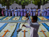 Sisters of Missionaries of Charity pray as a father spreads incense in front of graves during All Souls' Day observance at a cemetery 80 kil...