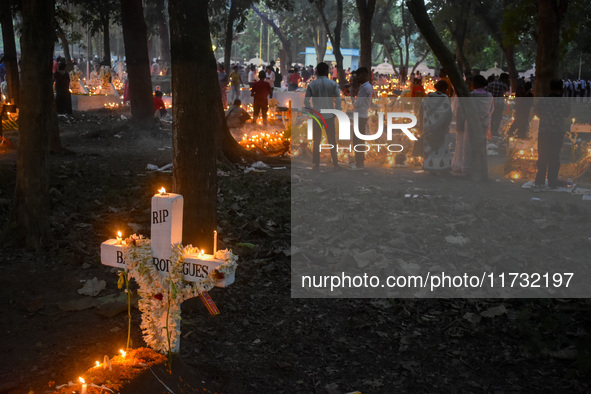 Candles are seen over graves during All Souls Day observance at a cemetery 80 kilometers outside Kolkata, India, on November 2, 2024. 