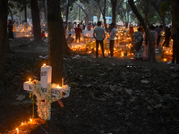 Candles are seen over graves during All Souls Day observance at a cemetery 80 kilometers outside Kolkata, India, on November 2, 2024. (