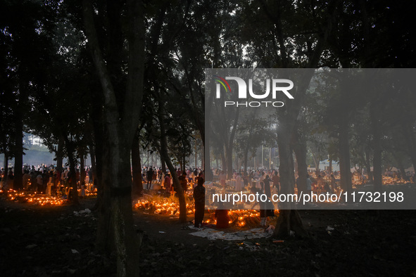 Candles are seen over graves during All Souls Day observance at a cemetery 80 kilometers outside Kolkata, India, on November 2, 2024. 