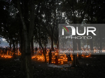 Candles are seen over graves during All Souls Day observance at a cemetery 80 kilometers outside Kolkata, India, on November 2, 2024. (