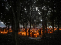 Candles are seen over graves during All Souls Day observance at a cemetery 80 kilometers outside Kolkata, India, on November 2, 2024. (