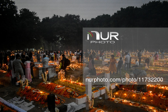 Candles are seen over graves during All Souls Day observance at a cemetery 80 kilometers outside Kolkata, India, on November 2, 2024. 