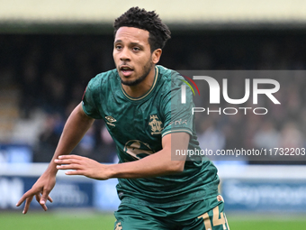 Korey Smith (14 Cambridge United) moves forward during the FA Cup First Round match between Woking and Cambridge United at the Kingfield Sta...