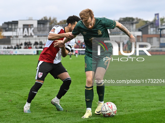 James Brophy (7, Cambridge United) controls the ball during the FA Cup First Round match between Woking and Cambridge United at the Kingfiel...