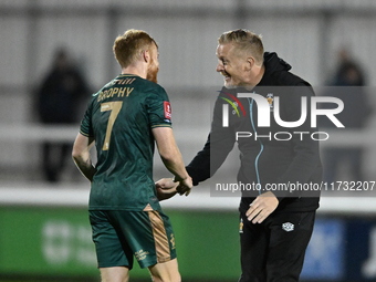 James Brophy of Cambridge United receives congratulations from Manager Garry Monk of Cambridge United after the final whistle during the FA...