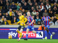 #20, Tommy Doyle of Wolves, is chased by #19, Will Hughes of Crystal Palace during the Premier League match between Wolverhampton Wanderers...