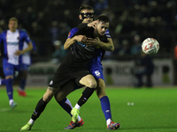 Sam Lavelle of Carlisle United holds back Joe Hugill of Wigan Athletic during the FA Cup First Round match between Carlisle United and Wigan...