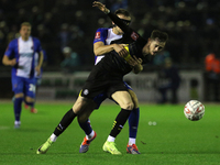 Sam Lavelle of Carlisle United holds back Joe Hugill of Wigan Athletic during the FA Cup First Round match between Carlisle United and Wigan...