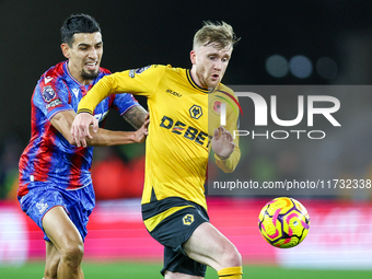 Number 20, Tommy Doyle of Wolves, is pressed by number 12, Daniel Munoz of Crystal Palace during the Premier League match between Wolverhamp...