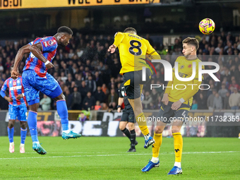 Marc Guehi of Crystal Palace heads the ball towards the goal as Joao Gomes of Wolves tries to intercept during the Premier League match betw...