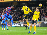 Marc Guehi of Crystal Palace heads the ball towards the goal as Joao Gomes of Wolves tries to intercept during the Premier League match betw...