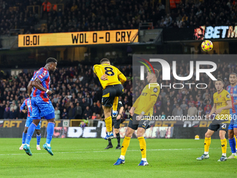 Marc Guehi of Crystal Palace heads the ball towards the goal as Joao Gomes of Wolves tries to intercept during the Premier League match betw...