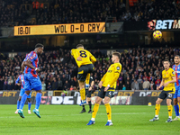 Marc Guehi of Crystal Palace heads the ball towards the goal as Joao Gomes of Wolves tries to intercept during the Premier League match betw...