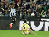 Jordan Zemura of Udinese is hindered by Manuel Locatelli of Juventus during the Italian Serie A Enilive soccer championship match between Ud...