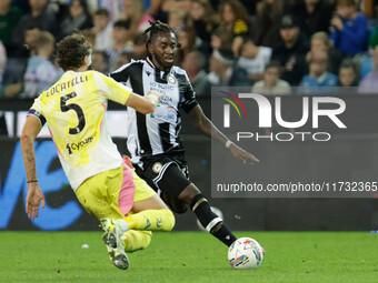 Jordan Zemura of Udinese is hindered by Manuel Locatelli of Juventus during the Italian Serie A Enilive soccer championship match between Ud...