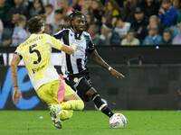 Jordan Zemura of Udinese is hindered by Manuel Locatelli of Juventus during the Italian Serie A Enilive soccer championship match between Ud...