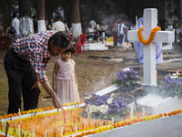 People from the Christian community light candles and offer prayers on the grave of their relative during the All Souls' Day observation in...