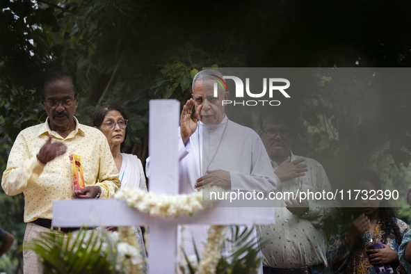 People from the Christian community light candles and offer prayers on the grave of their relative during the All Souls' Day observation in...