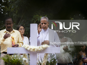 People from the Christian community light candles and offer prayers on the grave of their relative during the All Souls' Day observation in...