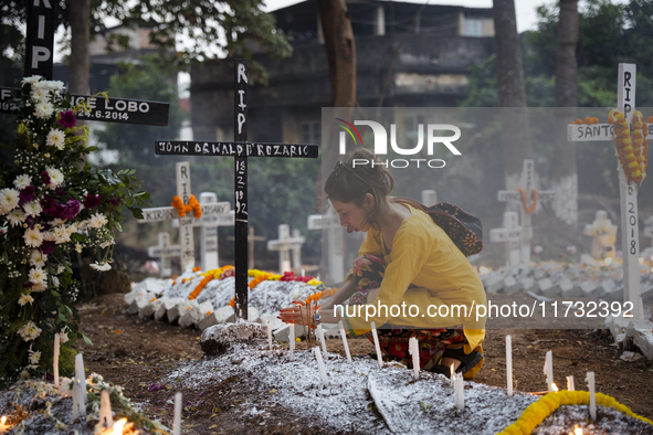 People from the Christian community light candles and offer prayers on the grave of their relative during the All Souls' Day observation in...