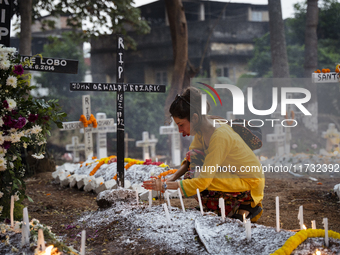 People from the Christian community light candles and offer prayers on the grave of their relative during the All Souls' Day observation in...