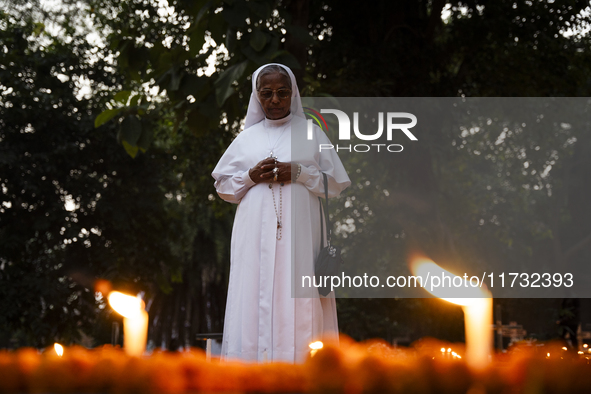 A nun offers prayers on the grave during the All Souls' Day observation in Guwahati, India, on November 2, 2024. All Souls' Day is a Christi...