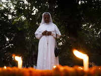 A nun offers prayers on the grave during the All Souls' Day observation in Guwahati, India, on November 2, 2024. All Souls' Day is a Christi...