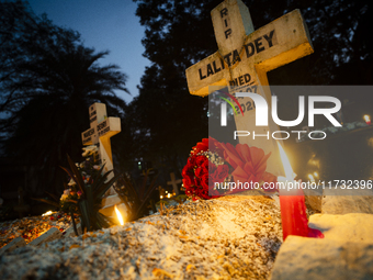 People from the Christian community light candles and offer prayers on the grave of their relative during the All Souls' Day observation in...