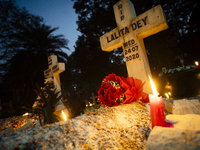 People from the Christian community light candles and offer prayers on the grave of their relative during the All Souls' Day observation in...