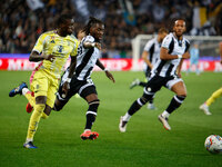 Timothy Weah of Juventus plays against Kingsley Ehizibue of Udinese during the Italian Serie A Enilive soccer championship match between Udi...