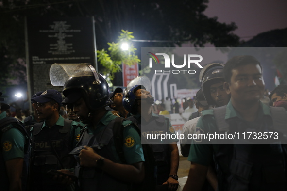 Law enforcers escort a minority protest as they demand protections for Hindus and other minorities in Dhaka, Bangladesh, on November 2, 2024...