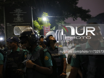 Law enforcers escort a minority protest as they demand protections for Hindus and other minorities in Dhaka, Bangladesh, on November 2, 2024...