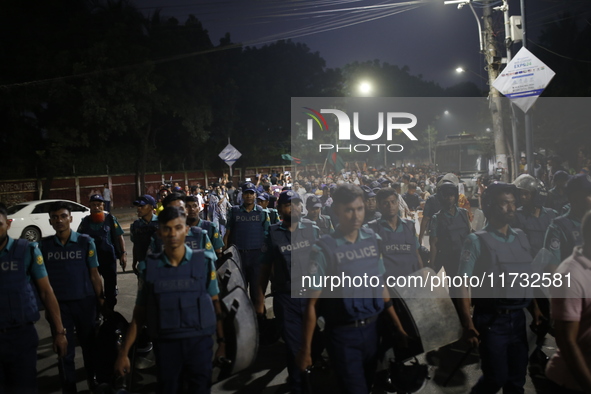 Law enforcers escort a minority protest as they demand protections for Hindus and other minorities in Dhaka, Bangladesh, on November 2, 2024...