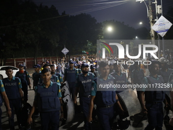 Law enforcers escort a minority protest as they demand protections for Hindus and other minorities in Dhaka, Bangladesh, on November 2, 2024...