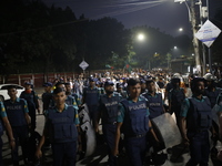 Law enforcers escort a minority protest as they demand protections for Hindus and other minorities in Dhaka, Bangladesh, on November 2, 2024...