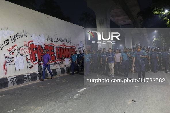 Law enforcers escort a minority protest as they demand protections for Hindus and other minorities in Dhaka, Bangladesh, on November 2, 2024...