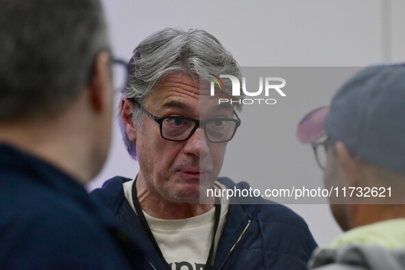 Alain Marschall and Olivier Truchot attend the first book fair in Valence, Drome, on November 2, 2024. 